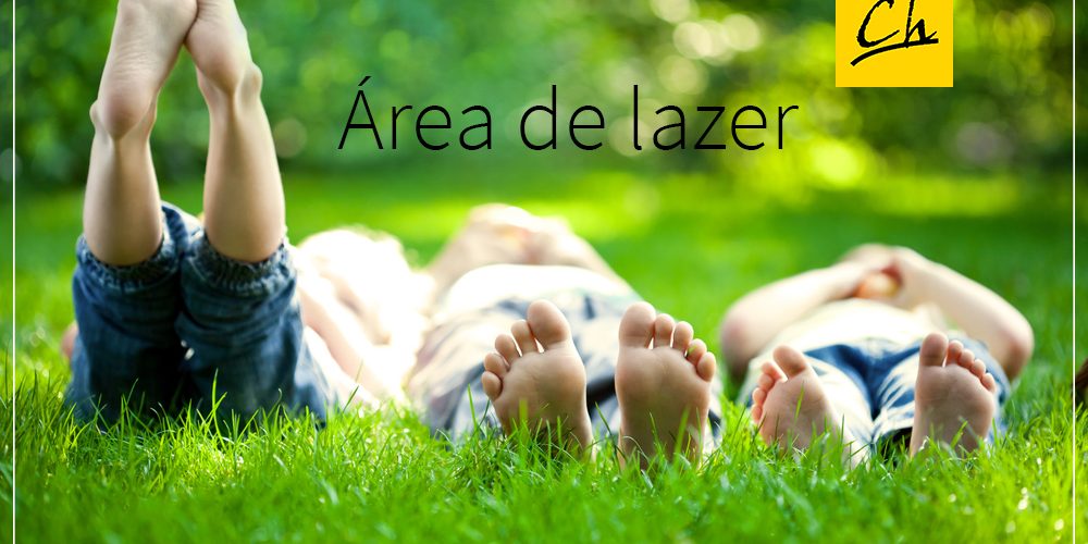 Group of happy children lying on green grass outdoors in spring park